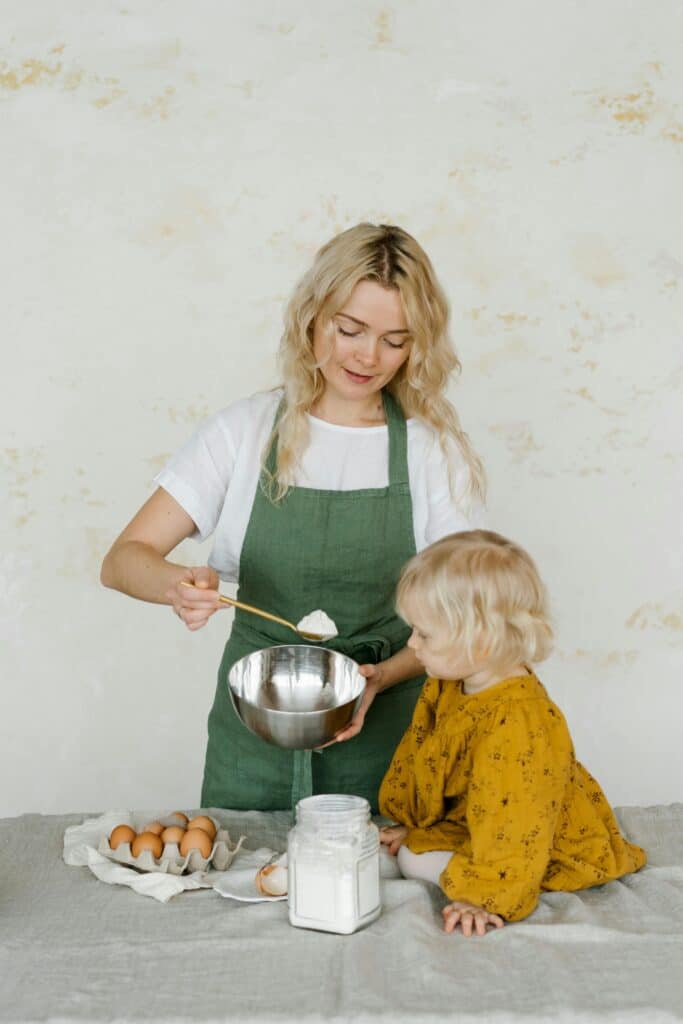 Amber Wilson smiling while testing a food hack in a vibrant, organized kitchen, embodying the joy of GlowUpKitchen